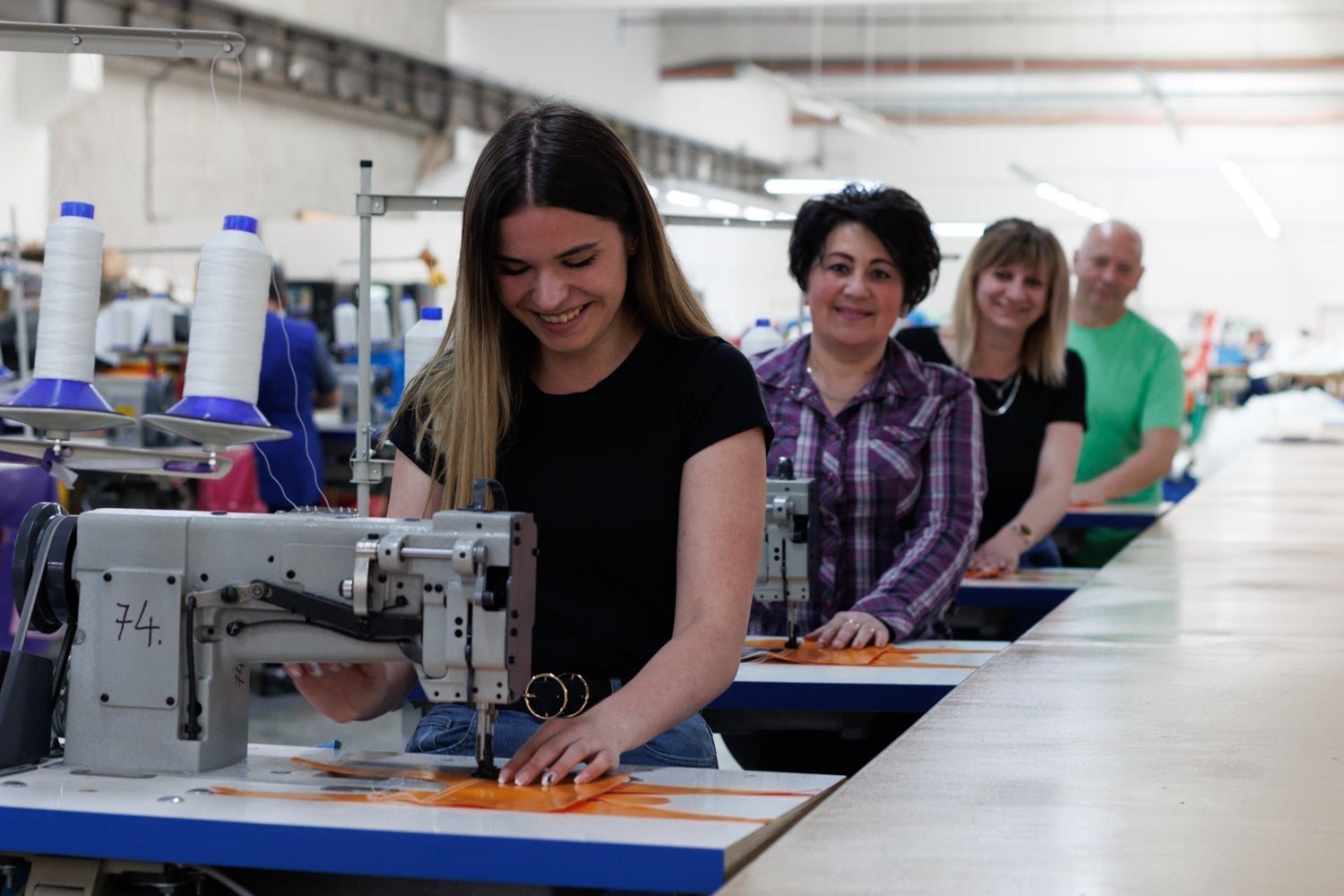 Airquee employees stitching inflatables