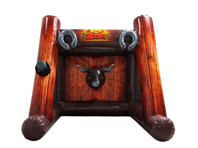 Inflatable bull ring arena game with a rustic wooden design, featuring a bull head target in the center, two metal bull rings at the top, and a 'Wild West Rudo' logo at the top center, isolated on a white background.