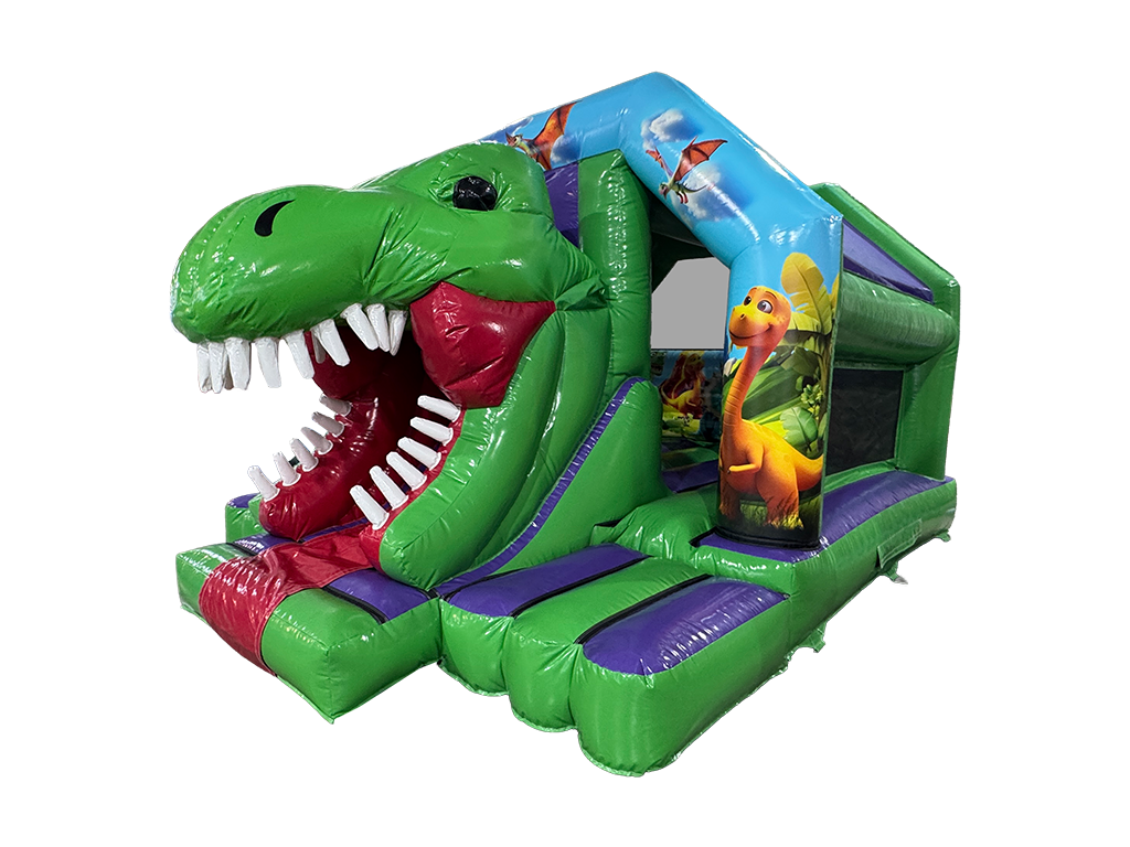 A green inflatable dinosaur-themed bouncy castle with a slide shaped like a dinosaur head, featuring white teeth, a red mouth interior, purple steps, and dinosaur illustrations on the side panels.