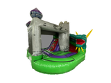 Airquee Dragon's Lair Combi inflatable bouncy castle with a 3D dragon, medieval tower design, and integrated slide.