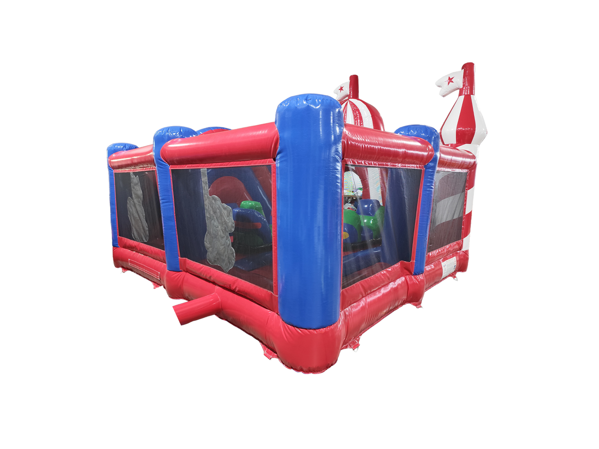 Airquee Fun Fair Multiplay inflatable with red and blue PVC walls, mesh sides, and circus-themed roof accents.