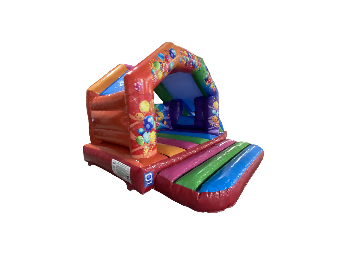 Airquee 6x4m multicoloured party bouncy castle with side slide, featuring bright balloon and streamer graphics.