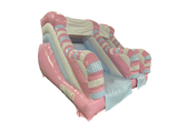 Airquee 1.5m pastel inflatable slide in pink, blue, and white with a twist design for children's parties.